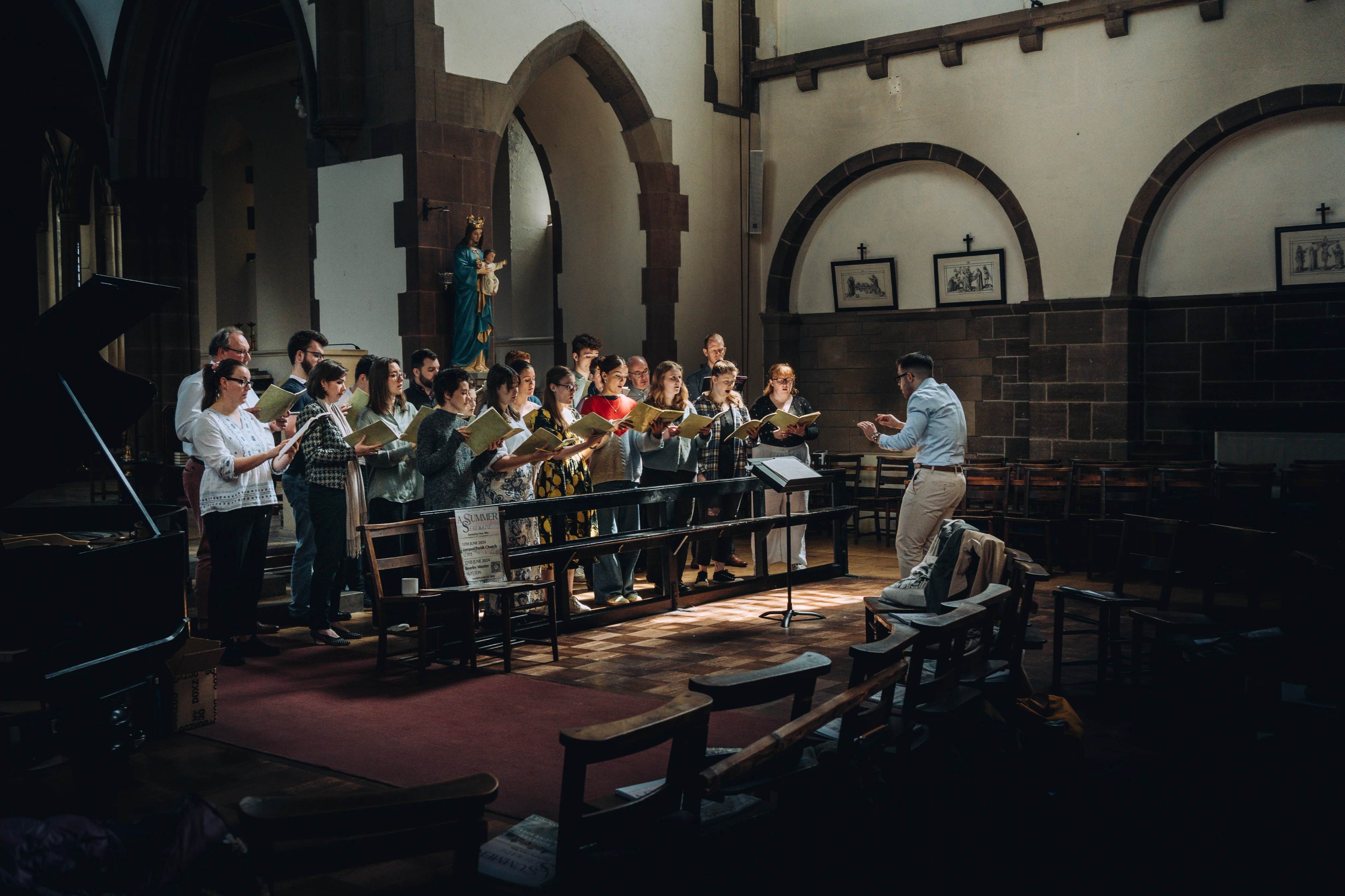 Chris conducting in front of a group of singers